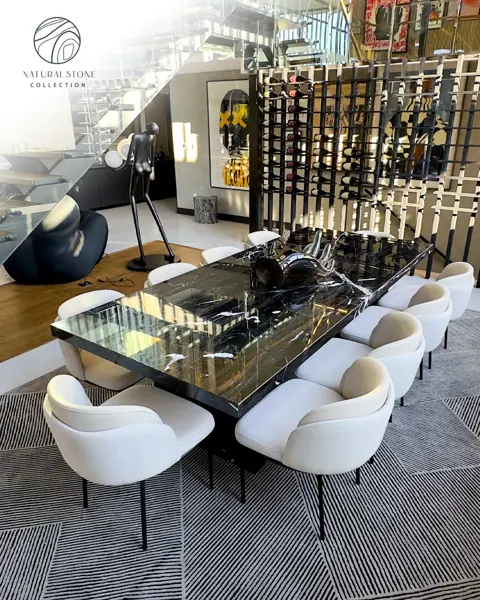 Black marble with white veining is used for the dining table, alongside a wine display and upholstered dining chairs.