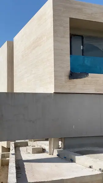 Soft cream stone is used for the exterior walls and entrance, alongside clean architectural lines and contemporary fittings.