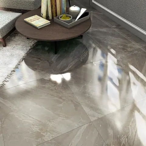 Polished grey stone is used for the floor throughout the room, alongside comfortable seating and a restrained neutral palette.