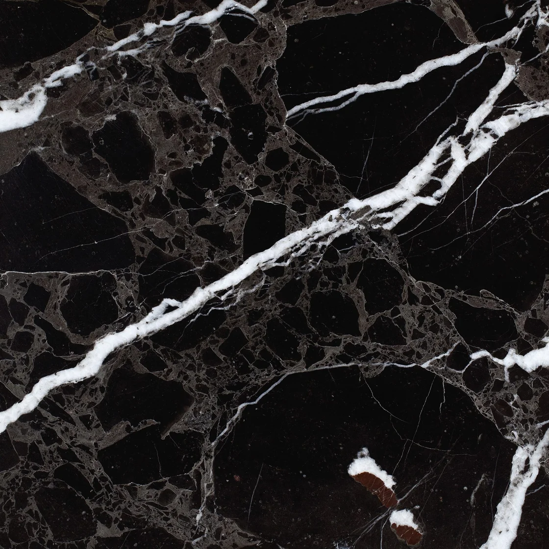 Alanya Siyah Mermer | marble tile Alanya Siyah Mermer marble tile — a near-black background, a bold white diagonal vein with finer intersecting lines